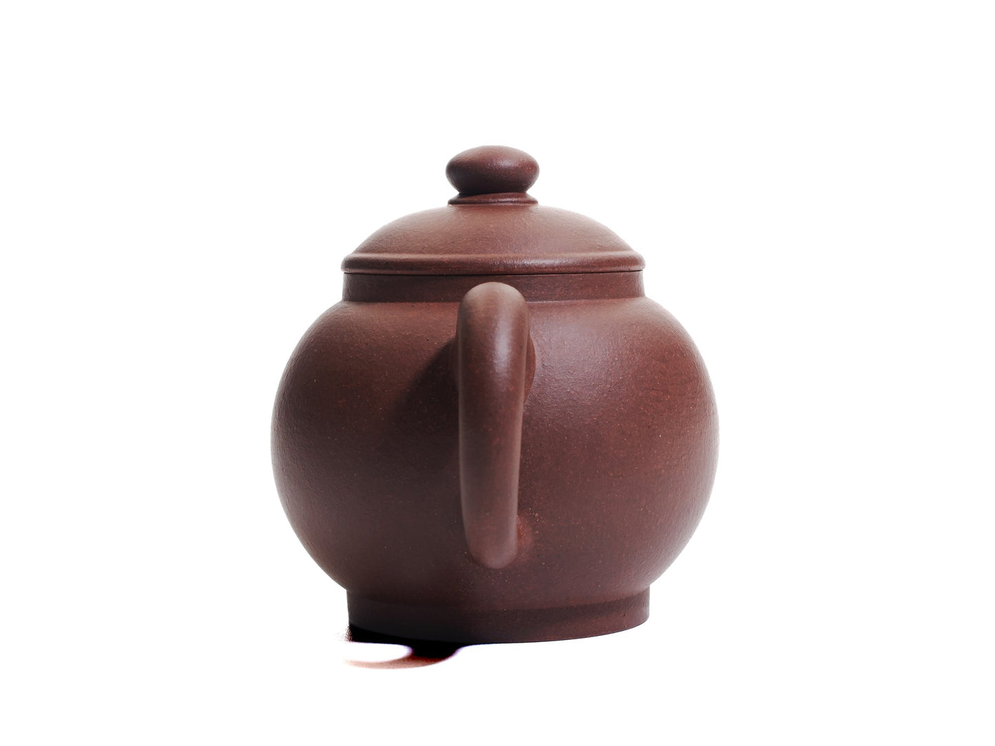 Back view of the Ju Lun Zhu teapot highlighting the curved handle and smooth clay surface.