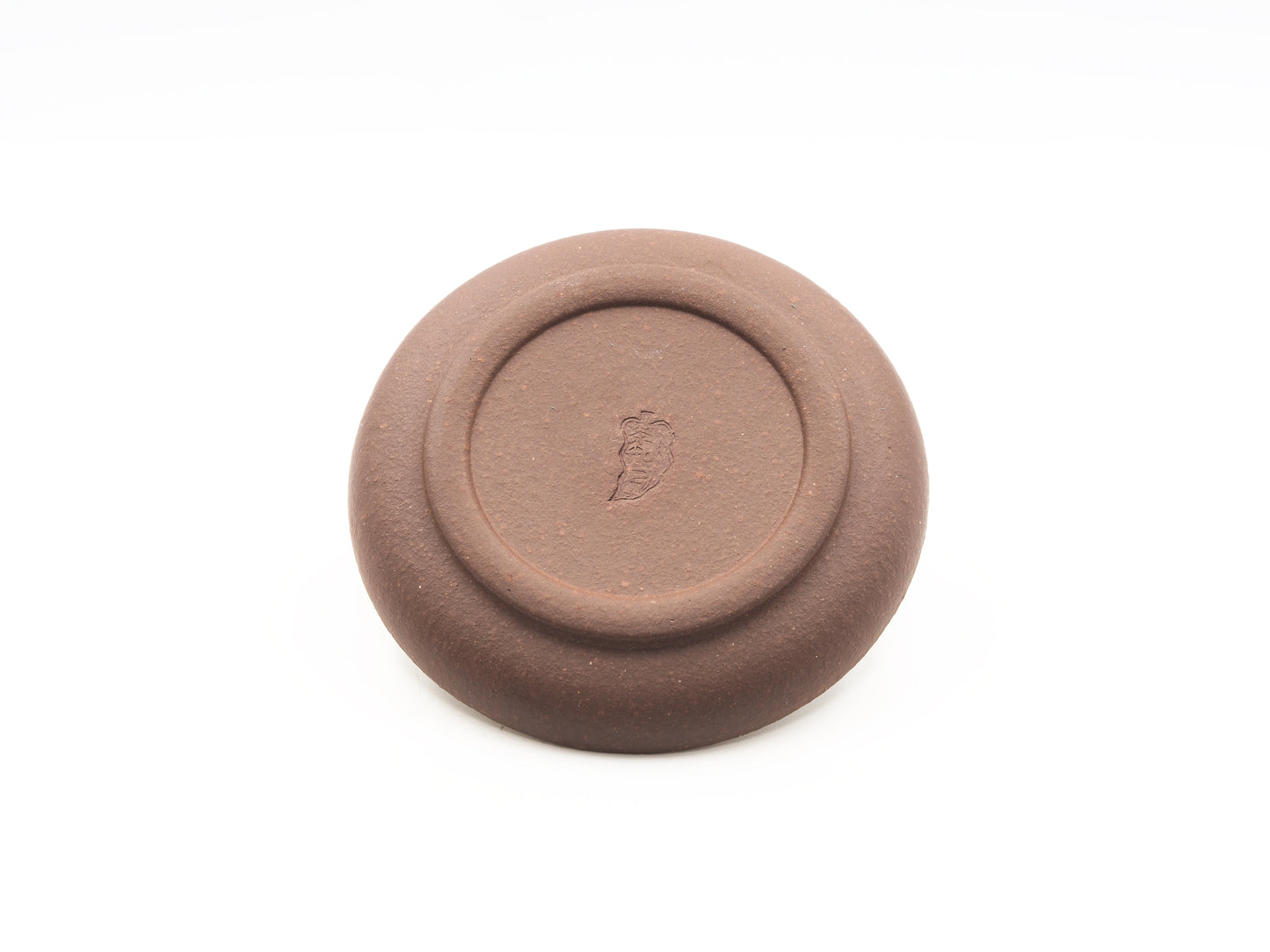 Bottom view of Yixing Dehou tea coaster with artist seal in aged purple clay