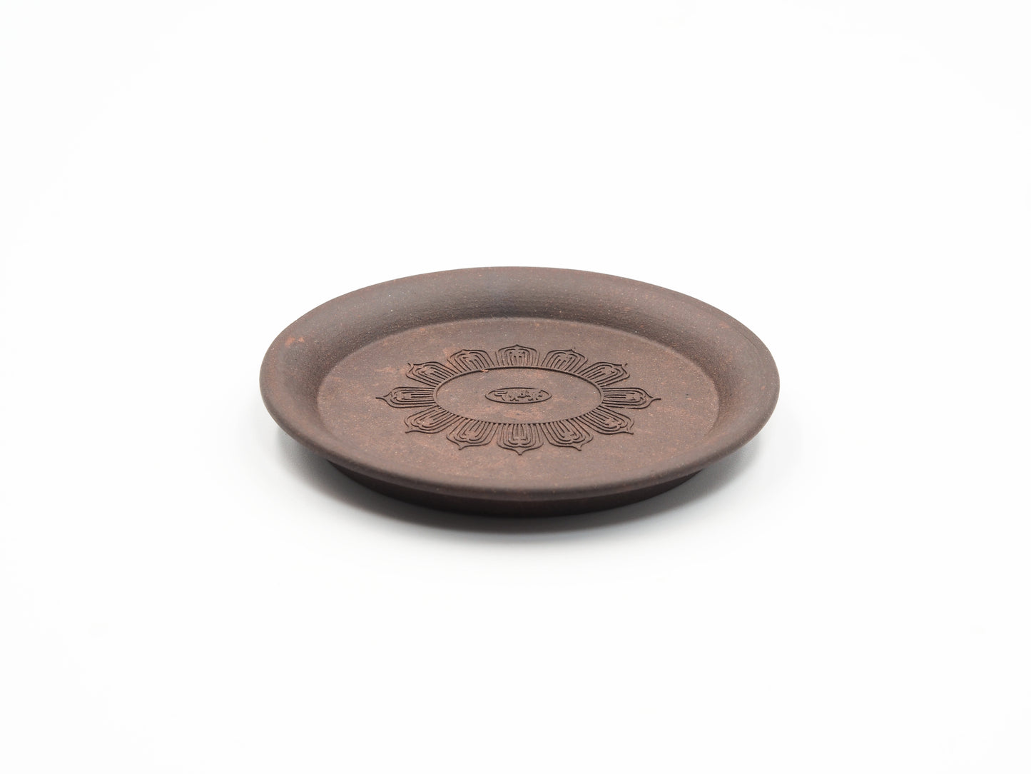 Angled view highlighting the floral engraving on the Yixing tea coaster