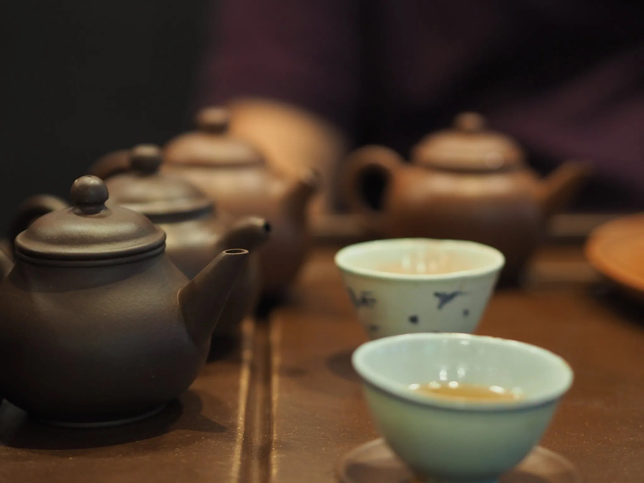 Yixing teapots with Ming and Qing dynasty antique teacups arranged for Gongfu tea session at Cha Zhi Ji