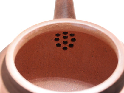 Close-up of the internal filter holes inside the Diamond Grade teapot, showing the clean clay work.