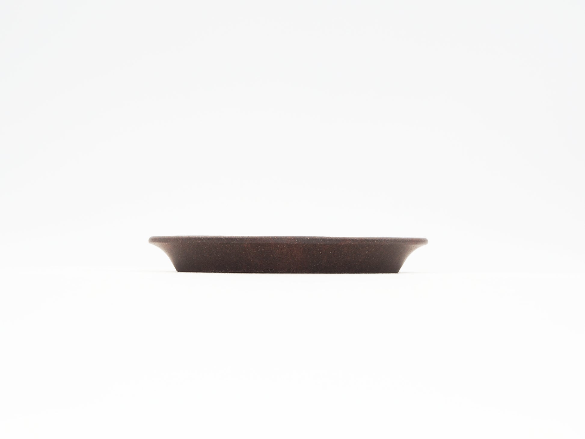Side profile of the Oval Yixing Tea Coaster showing elegant curves and flat design